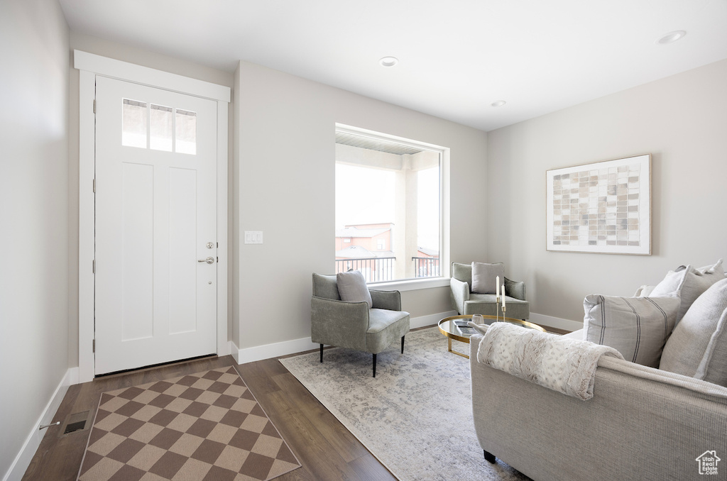 Interior space featuring recessed lighting, baseboards, dark wood-style floors, and visible vents