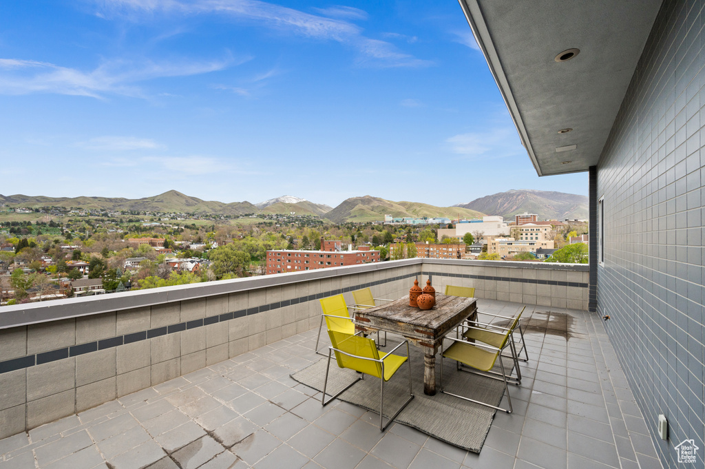 Balcony featuring a mountain view and outdoor dining space