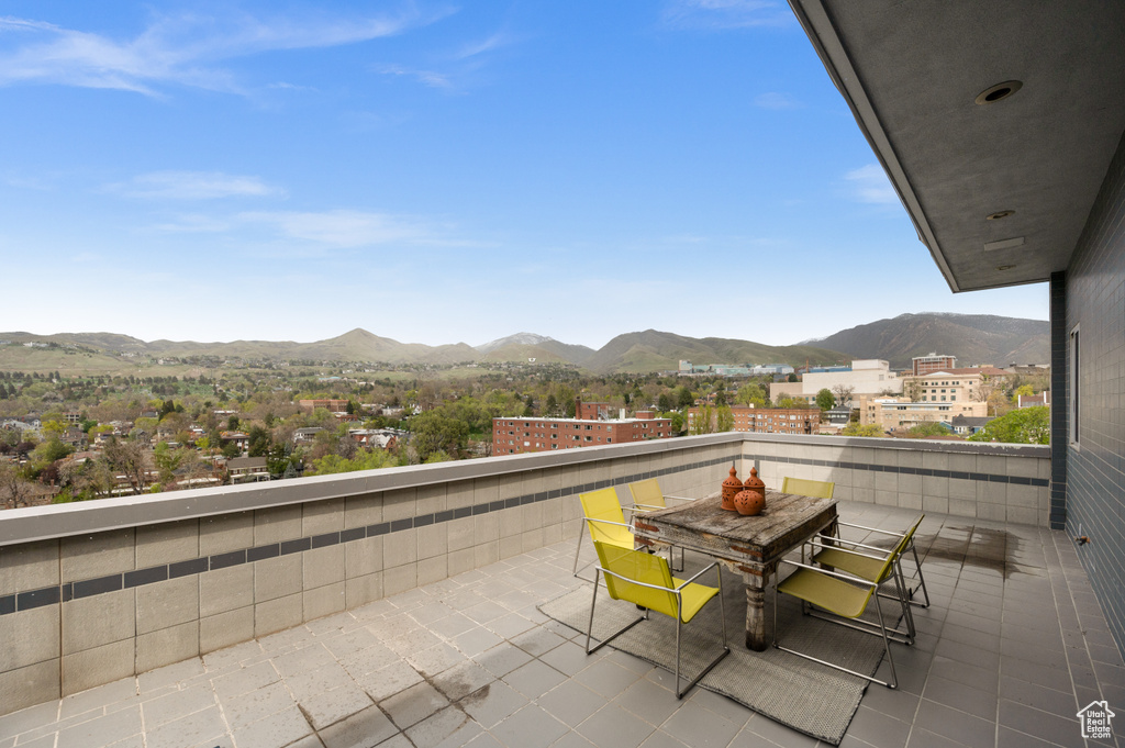 Balcony with outdoor dining area and a mountain view