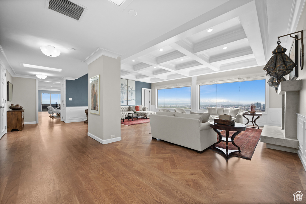 Living room with visible vents, beam ceiling, ornamental molding, coffered ceiling, and recessed lighting