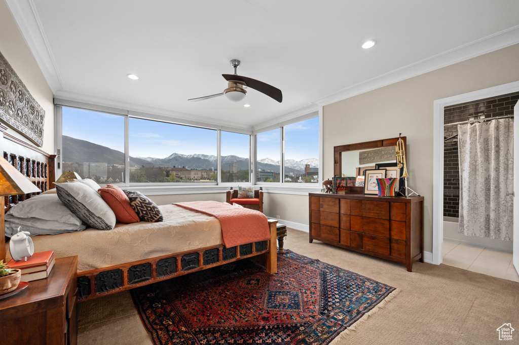 Bedroom with crown molding, recessed lighting, a mountain view, and light colored carpet