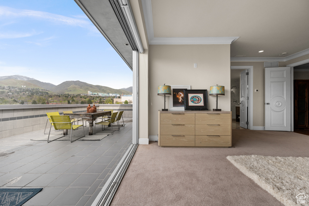 Interior space with baseboards, ornamental molding, and a mountain view