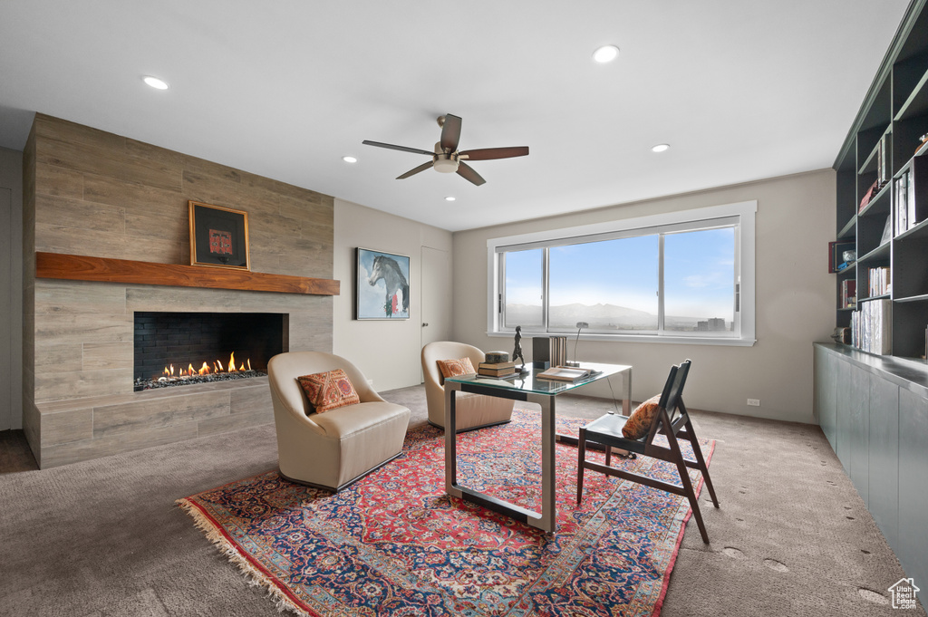 Office space with a ceiling fan, carpet flooring, recessed lighting, and a tile fireplace