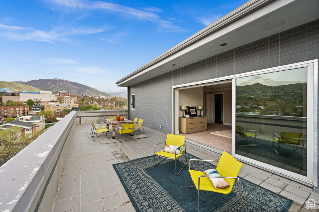 View of patio with a mountain view and outdoor dining space