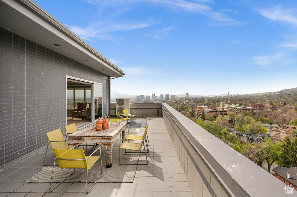 Balcony featuring a view of city and a mountain view
