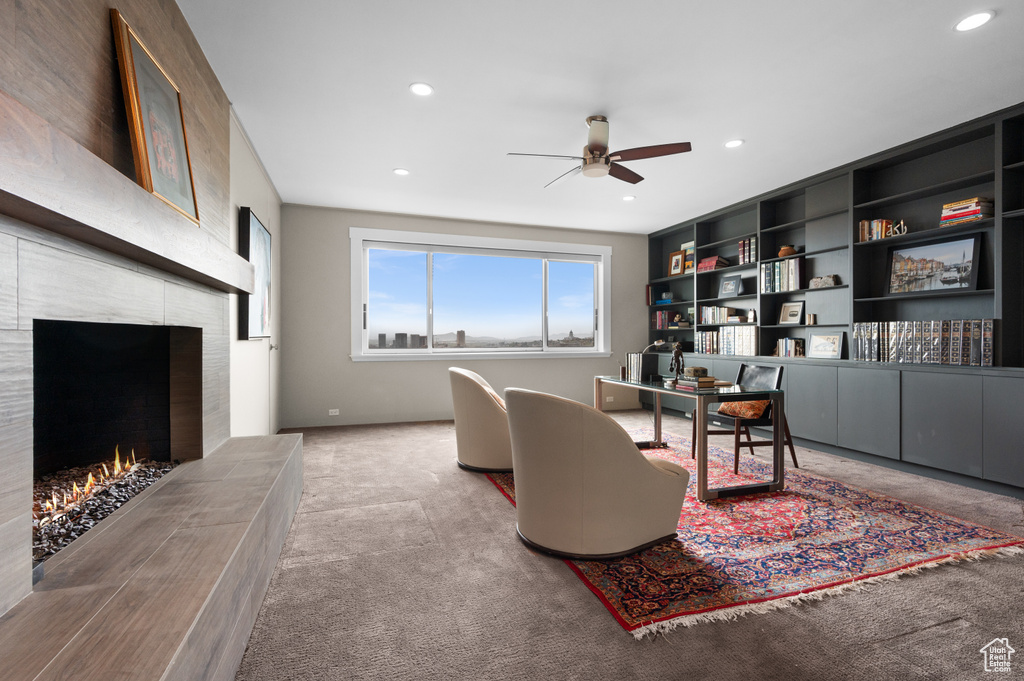 Living area featuring recessed lighting, carpet, ceiling fan, and a tiled fireplace