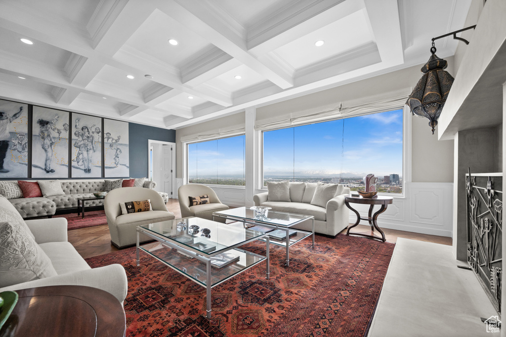 Living area featuring a decorative wall, recessed lighting, beamed ceiling, and coffered ceiling