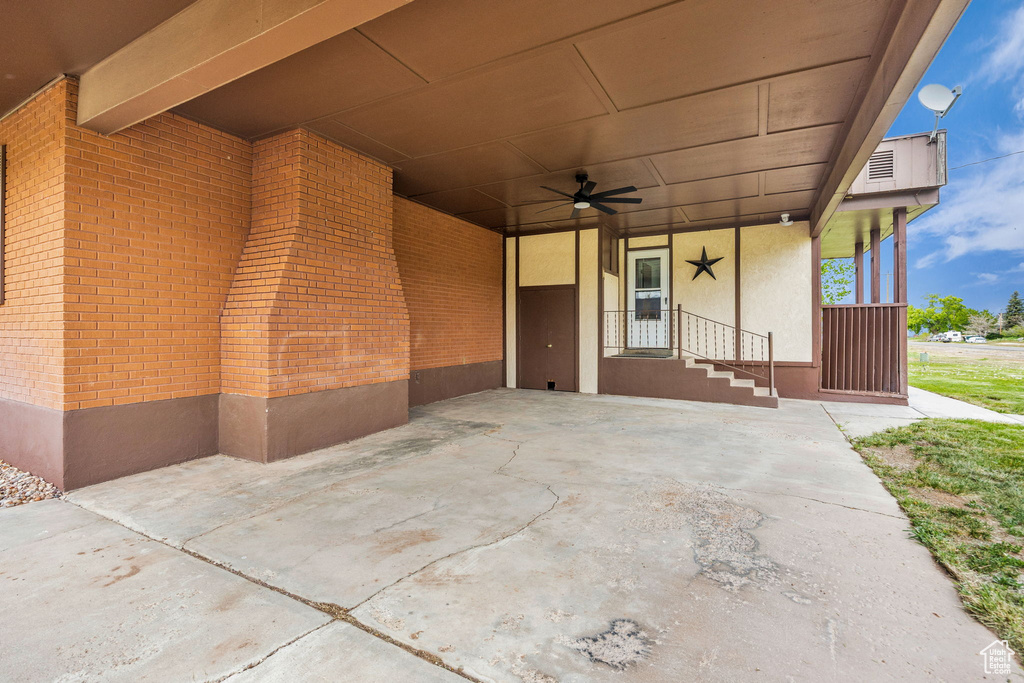 View of patio with a ceiling fan and an attached carport