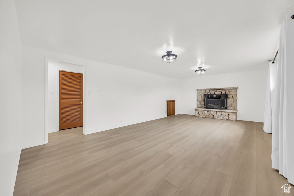 Unfurnished living room featuring light wood-style floors and a fireplace