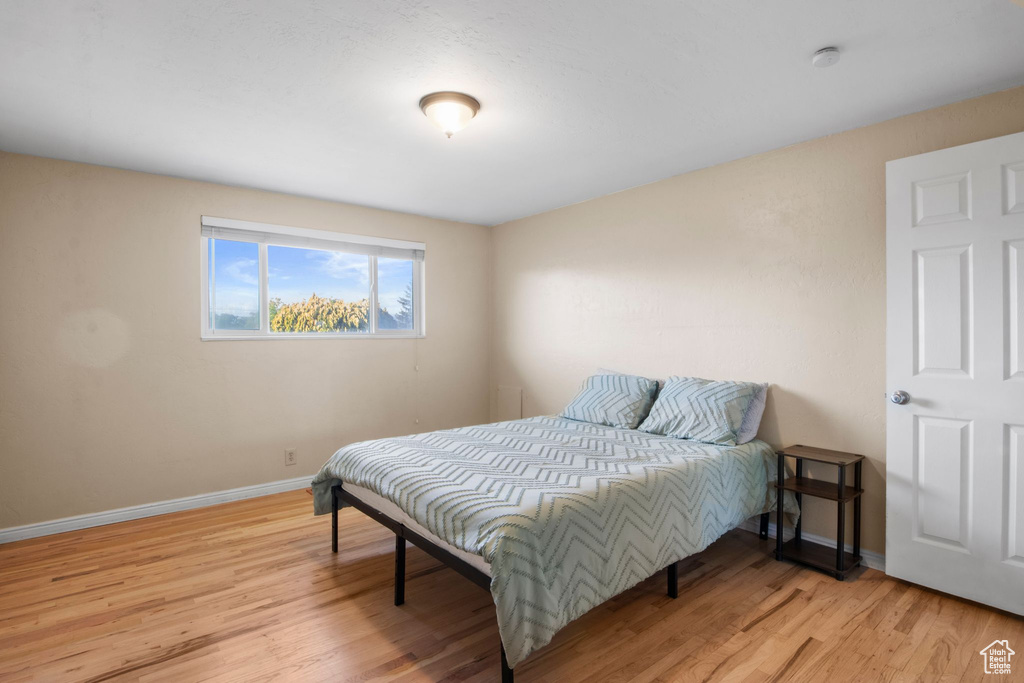 Bedroom featuring baseboards and wood finished floors