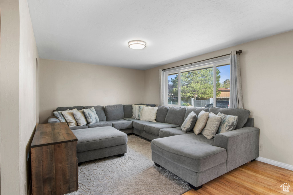 Living room featuring light wood-type flooring and baseboards