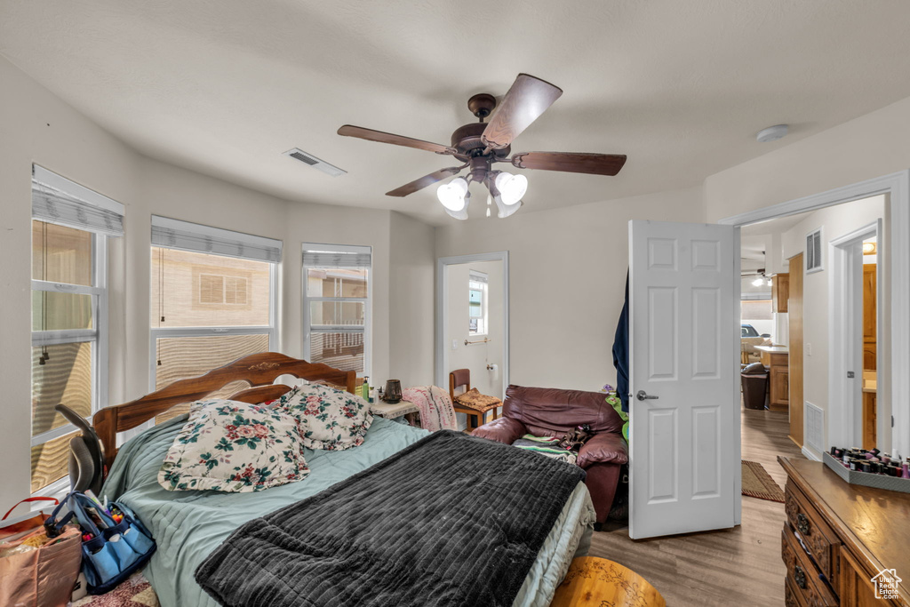 Bedroom featuring visible vents, ceiling fan, and wood finished floors