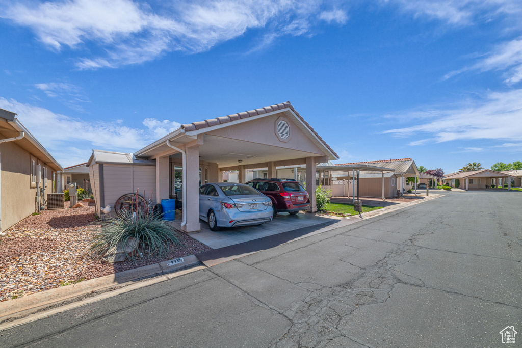 View of car parking featuring a residential view and an attached carport