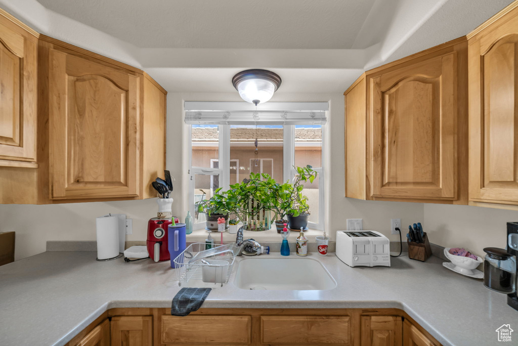 Kitchen featuring light countertops and a sink