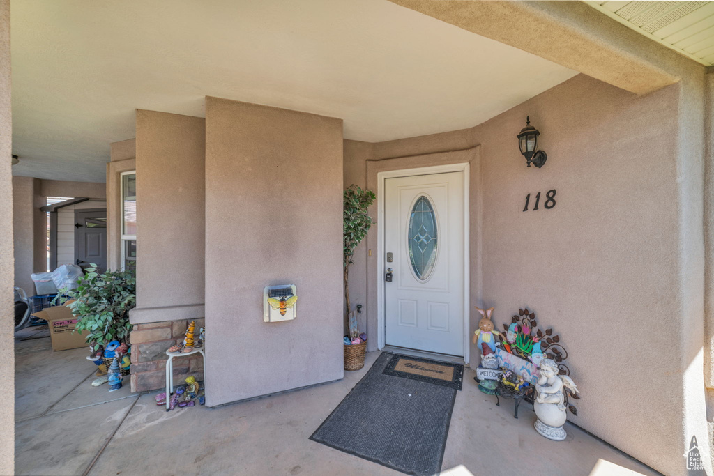 Property entrance featuring stucco siding
