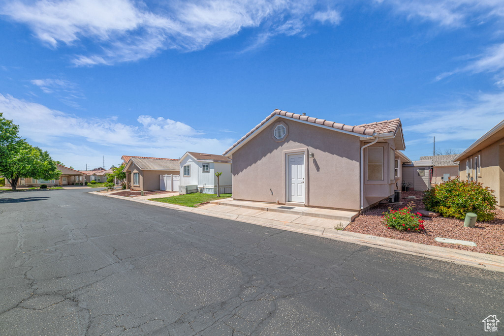 View of front of home with a residential view, stucco siding, and a tile roof