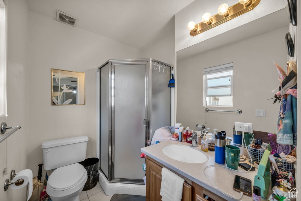 Full bath featuring vanity, a stall shower, toilet, and visible vents