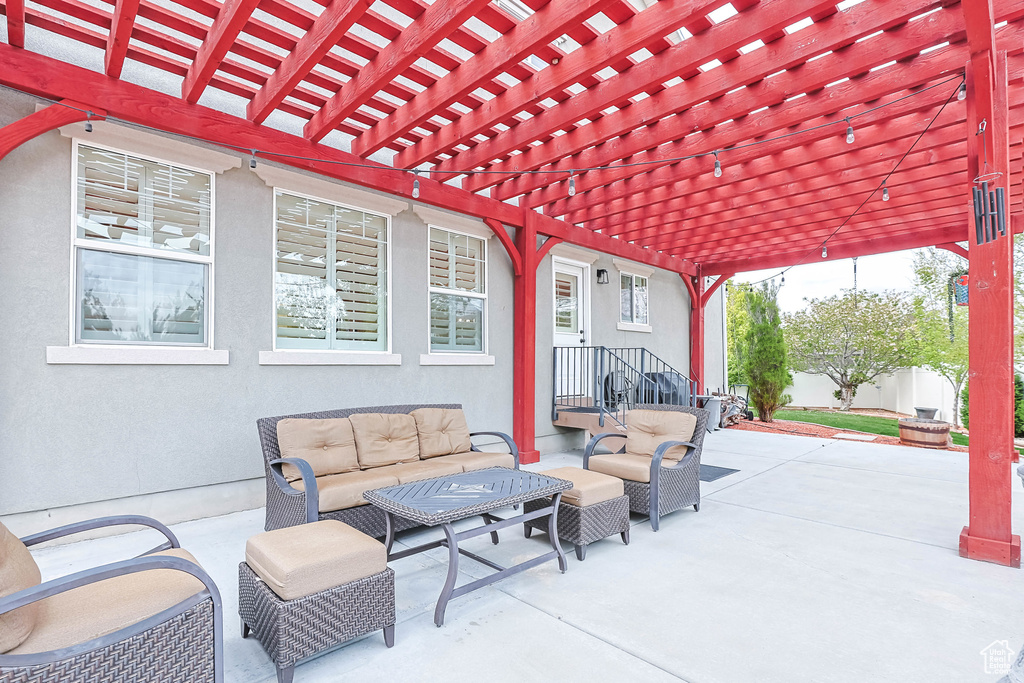 View of patio / terrace featuring fence, outdoor lounge area, and a pergola