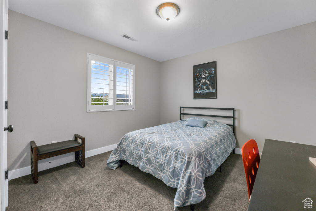 Bedroom with visible vents, carpet, and baseboards
