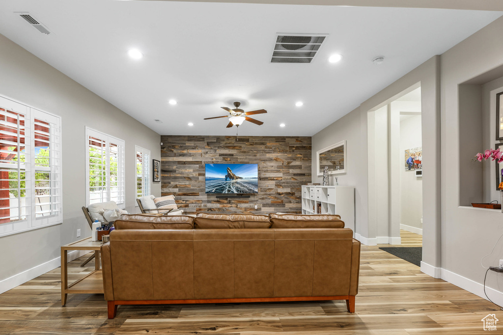 Living area with baseboards, recessed lighting, light wood-style flooring, and visible vents
