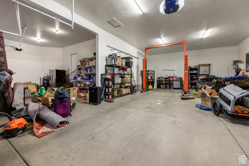 Garage featuring a garage door opener