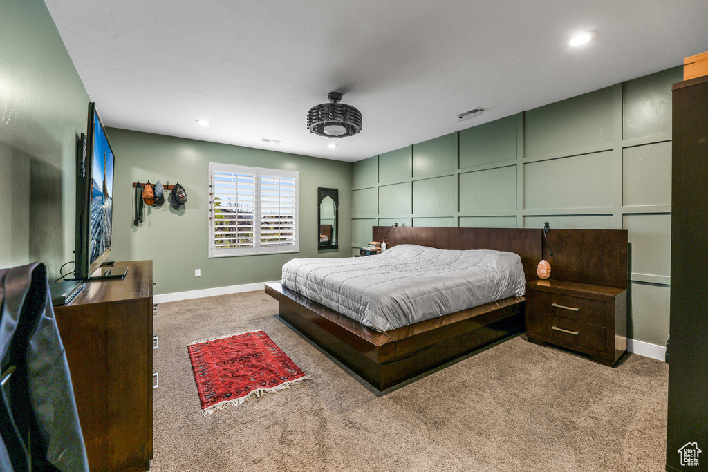 Bedroom with carpet floors, baseboards, recessed lighting, and visible vents