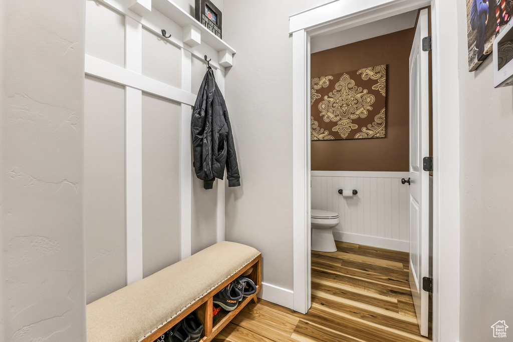 Mudroom with a wainscoted wall and light wood-style floors