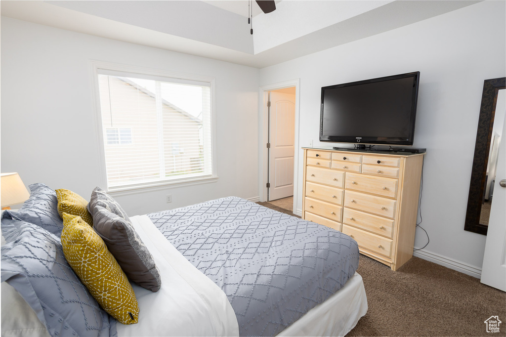 Bedroom featuring carpet floors, a ceiling fan, and baseboards