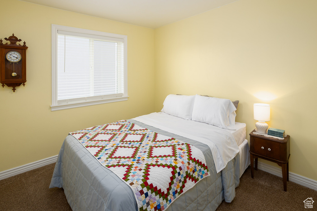 Bedroom with baseboards and carpet