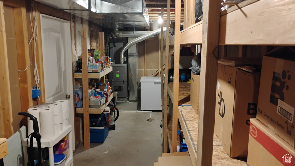 Unfinished below grade area featuring refrigerator