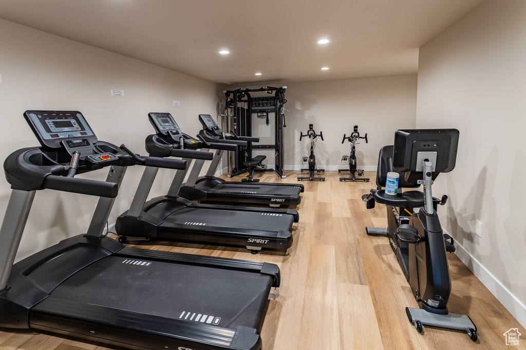 Workout area featuring baseboards, recessed lighting, and wood finished floors