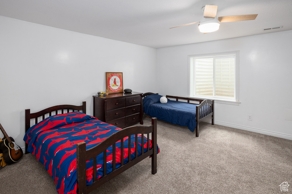 Bedroom with baseboards, a ceiling fan, carpet flooring, and visible vents