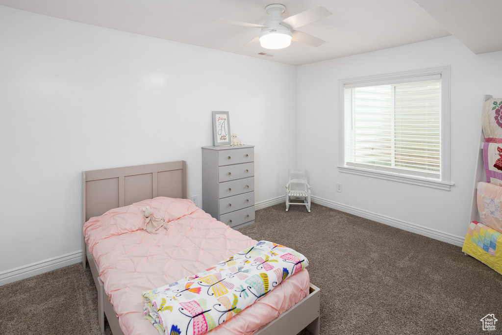 Bedroom featuring carpet floors, a ceiling fan, and baseboards