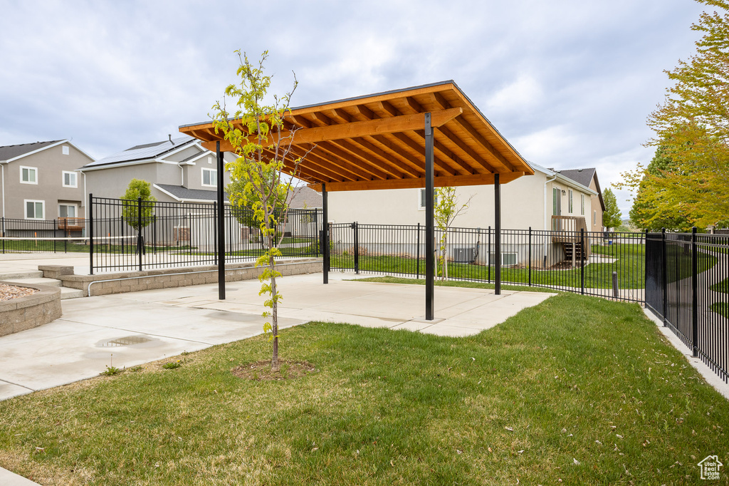 Surrounding community with a lawn, fence, and a residential view