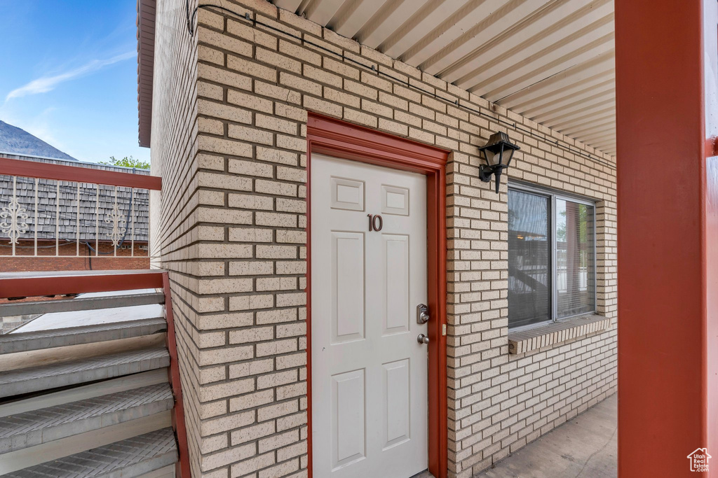 Doorway to property with brick siding