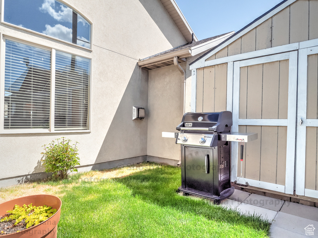 Exterior space featuring a lawn and stucco siding