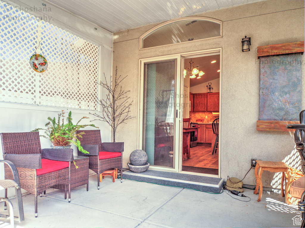 Property entrance with stucco siding and a patio area