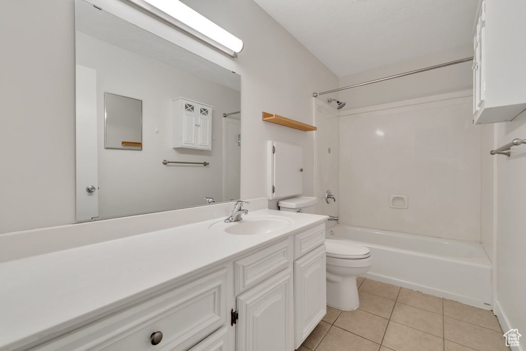 Full bathroom with tile patterned flooring, bathtub / shower combination, toilet, and vanity