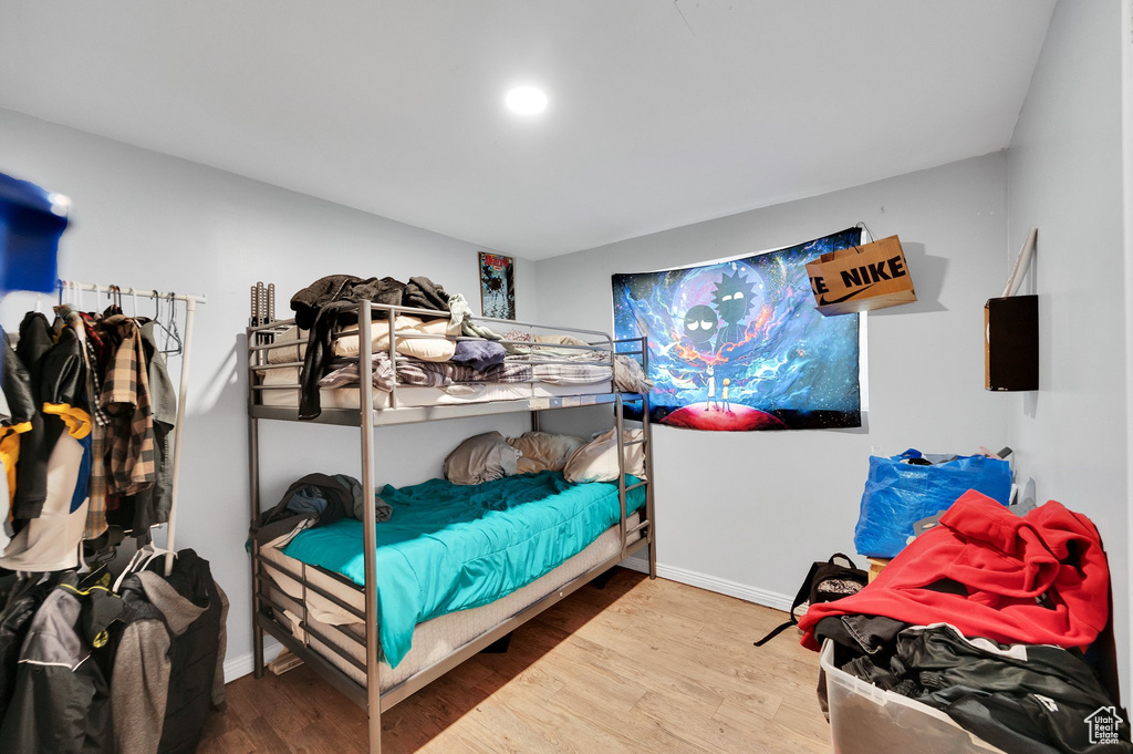 Bedroom featuring baseboards and wood finished floors