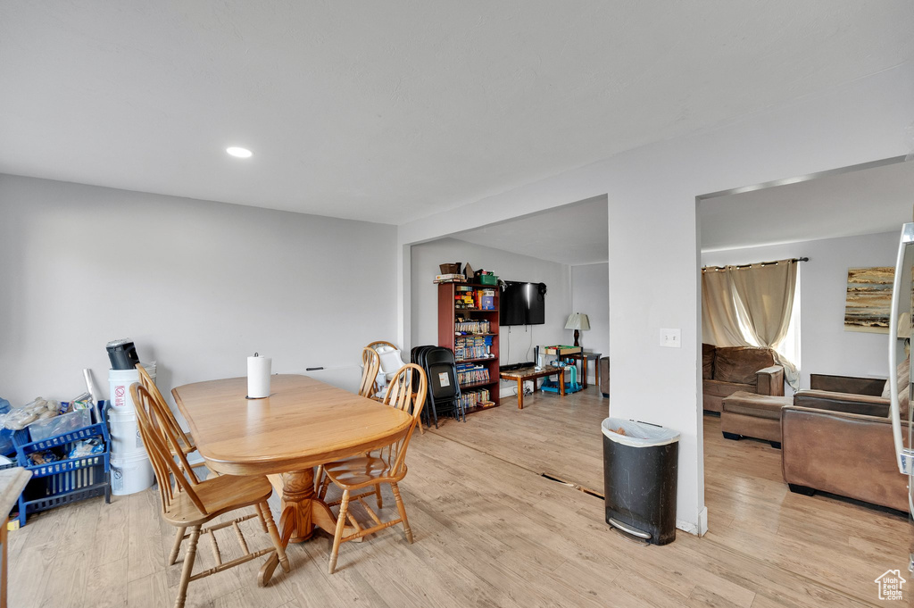 Dining space with recessed lighting and light wood finished floors