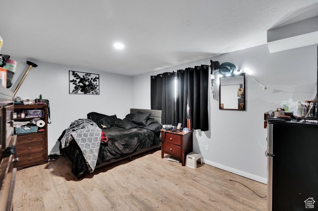 Bedroom featuring baseboards and wood finished floors