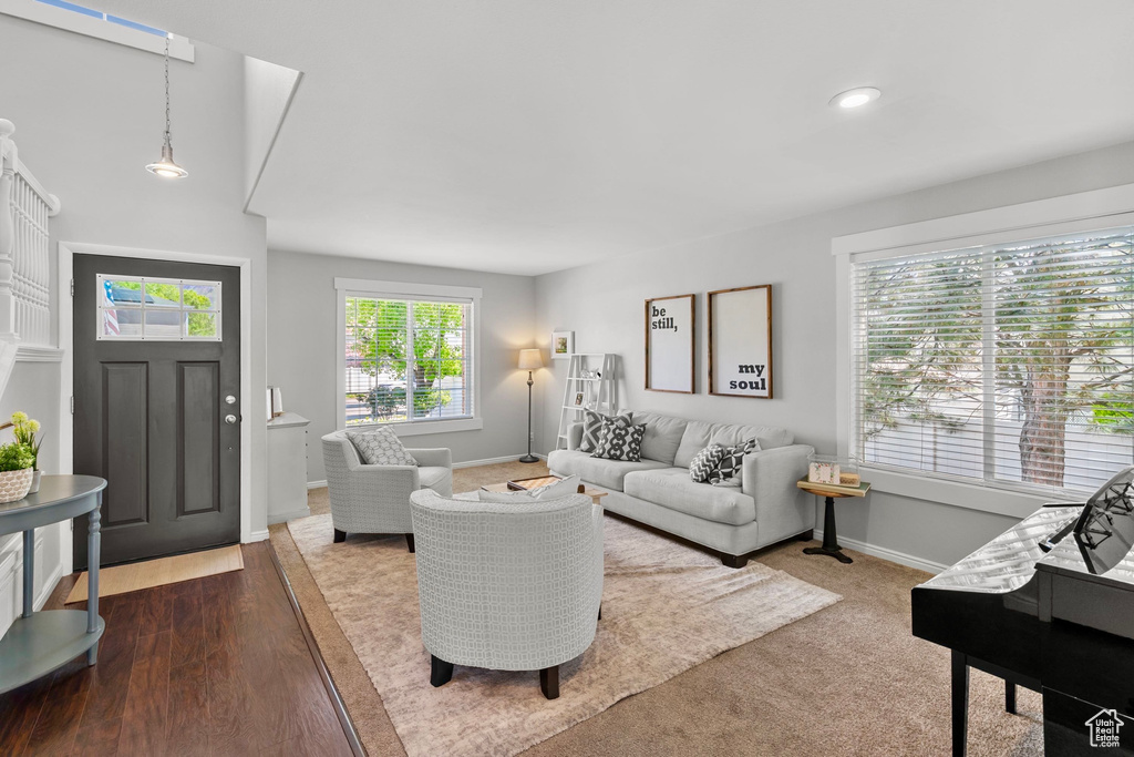 Living room with recessed lighting, baseboards, and dark wood-type flooring