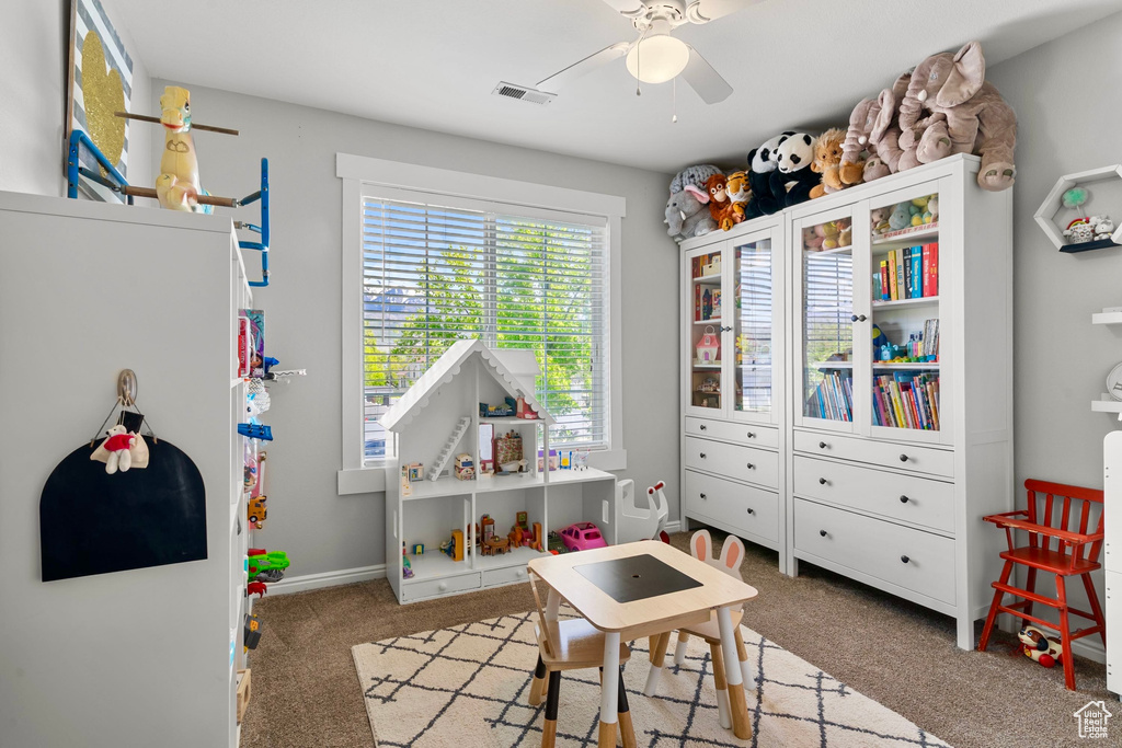 Game room with baseboards, a ceiling fan, carpet flooring, and visible vents