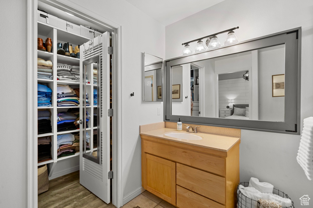 Full bath with a spacious closet and vanity