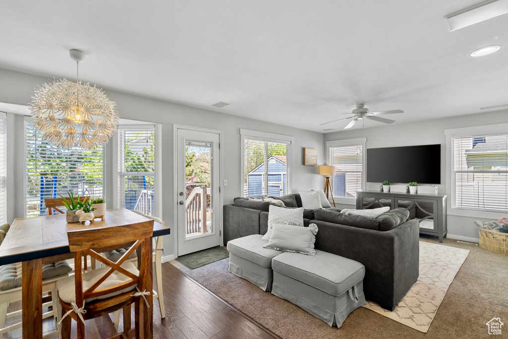 Living area with recessed lighting, baseboards, visible vents, and ceiling fan with notable chandelier
