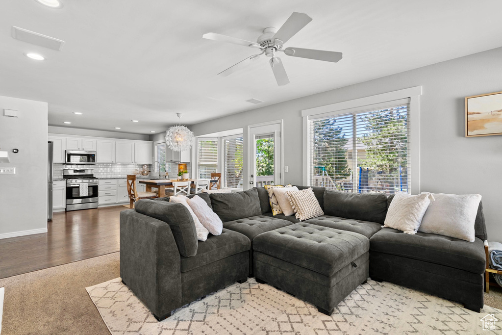 Living room with ceiling fan, light wood finished floors, recessed lighting, baseboards, and visible vents