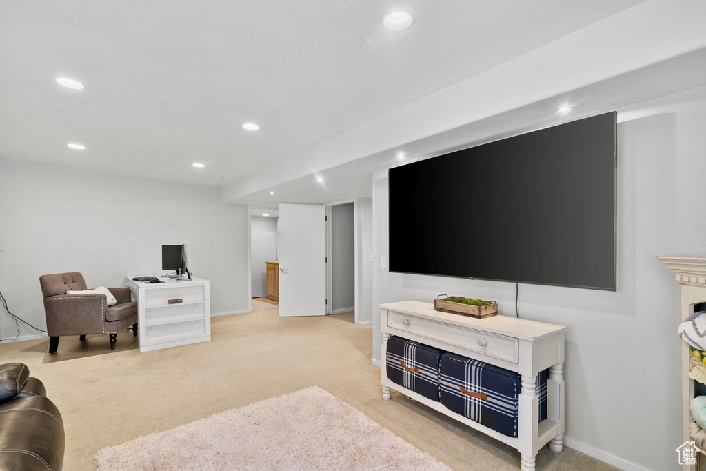 Living room with recessed lighting, baseboards, and light colored carpet