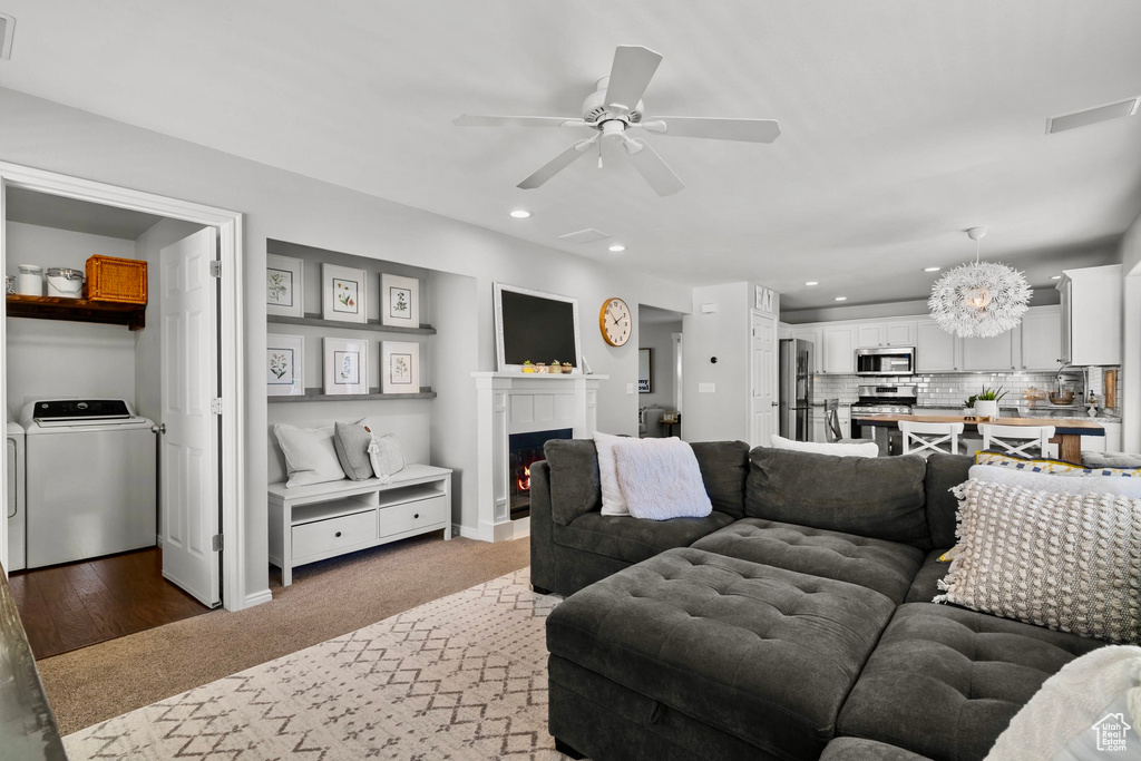 Living area featuring recessed lighting, a lit fireplace, ceiling fan, and light carpet