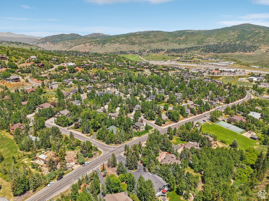 Aerial overview of property\\\\\\\'s location with a mountainous background and nearby suburban area