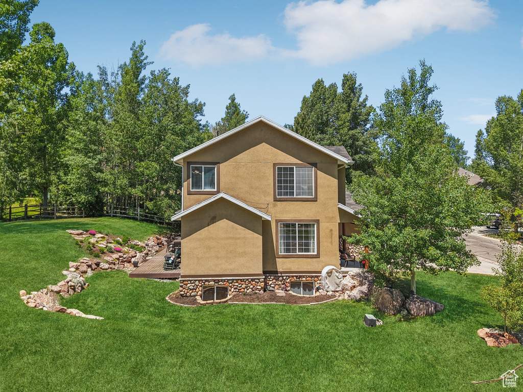 Rear view of property featuring stucco siding